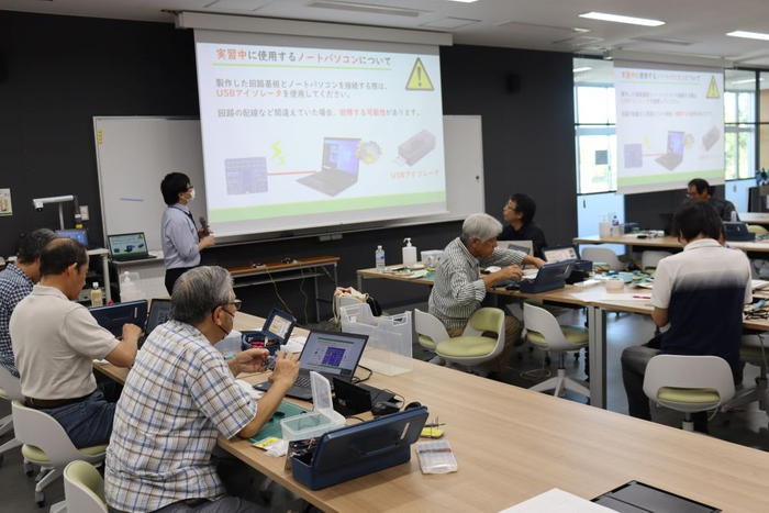 真剣な表情で説明に耳を傾ける受講生