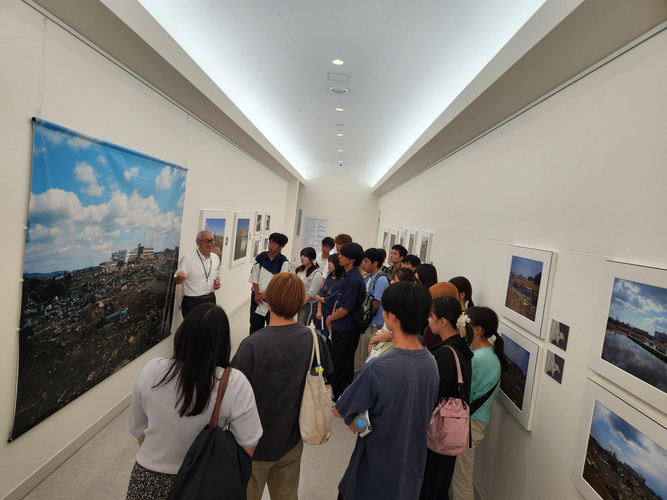 語り部の解説を聞く学生たち