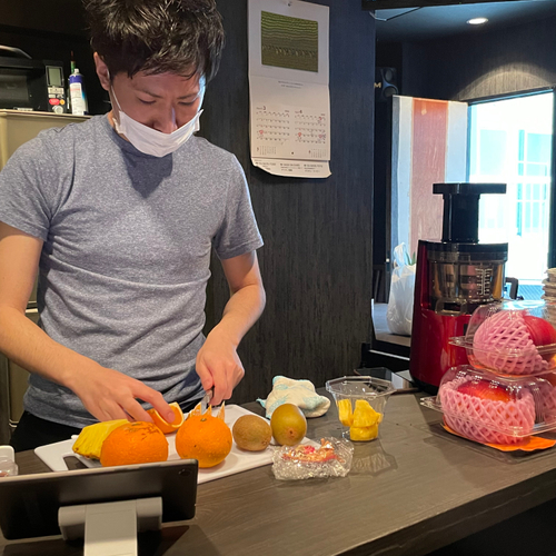 フルーツカップをカット中　